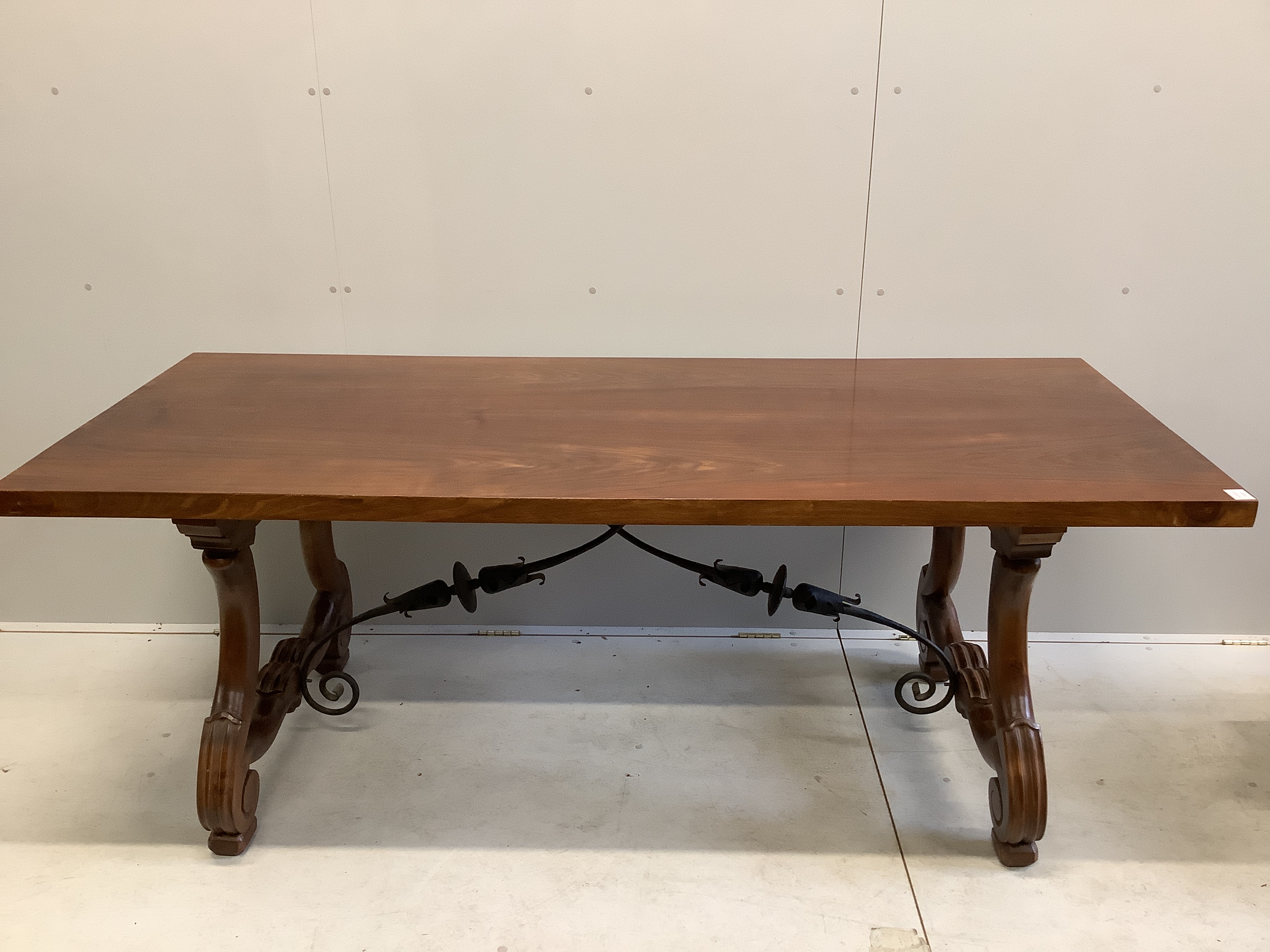 A Spanish walnut and fruitwood rectangular table, width 200cm, depth 84cm, height 77cm together with nine matching high back dining chairs